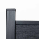 Black composite fence top corner with capped post, rail, and textured board