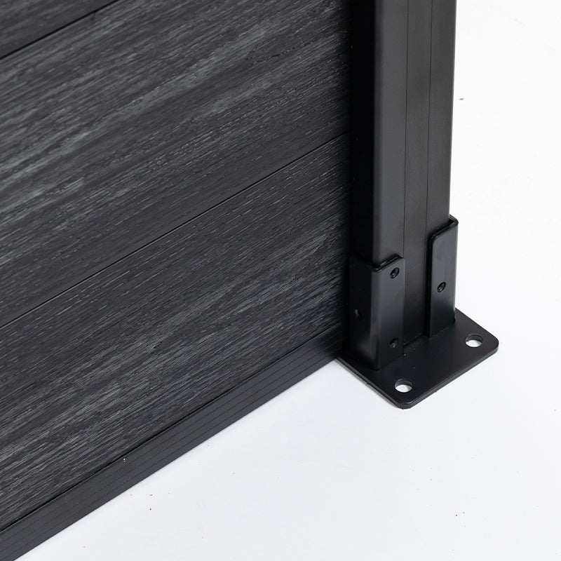 Lower corner of a black composite fence with post brackets and four-hole mounting plate