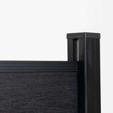 Black composite fence corner detail with capped post, top rail, and wood-grain panel