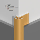 Gold rounded aluminum outside corner trim installed over white wall panels with profile dimensions