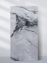 Light gray PVC marble sheet sample with a dark central stone accent and fine veining