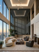 Double-height lounge with gray mirror wood veneer wall panels reflecting tall windows and seating