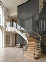 Gray mirror wood veneer panels installed on a tall feature wall beside a curved staircase