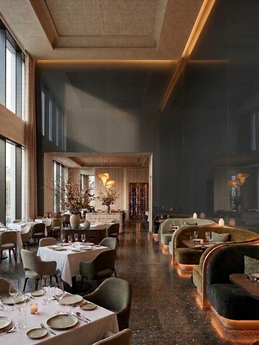 Upscale restaurant interior with gray mirror wood veneer panels reflecting tables and warm lighting
