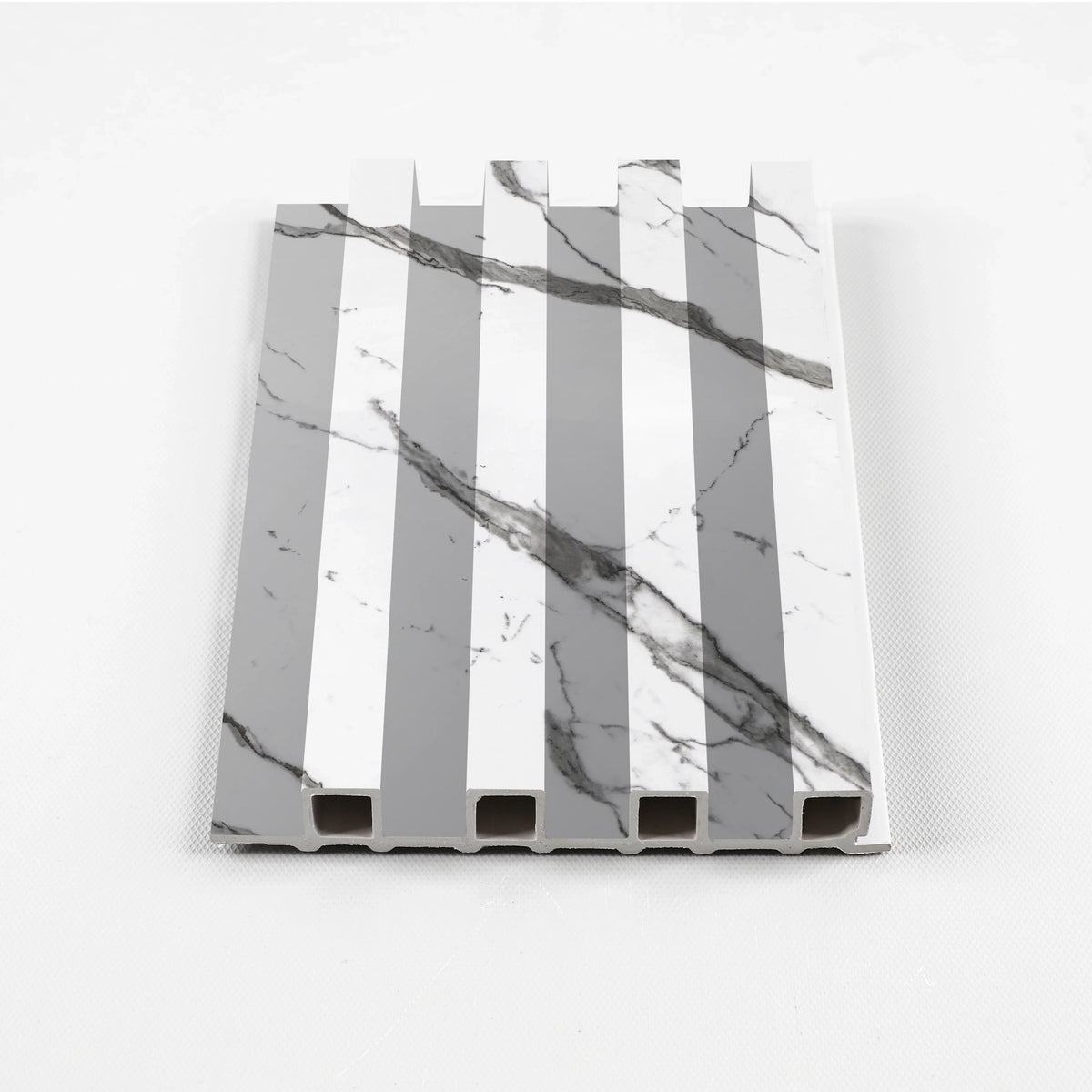 Gray vein WPC fluted wall panel sample with white marble-look surfaces