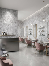 Gray stone-look PVC wall panels in a contemporary salon with mirrors and pink chairs