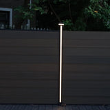 Warm white LED strip illuminating a post between dark composite fence panels