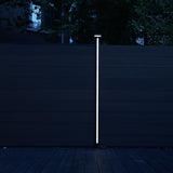 Bright white LED strip installed on a composite fence post at dusk