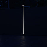 LED strip glowing vertically on a composite fence post at night