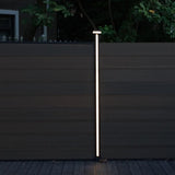 Vertical LED strip glowing on a composite garden fence post
