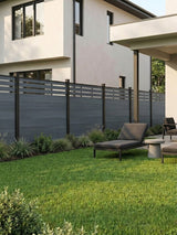 Light gray top lattice composite privacy fence installed around a modern backyard lawn and patio