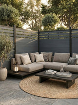 Light gray composite privacy fence enclosing an outdoor sectional seating area