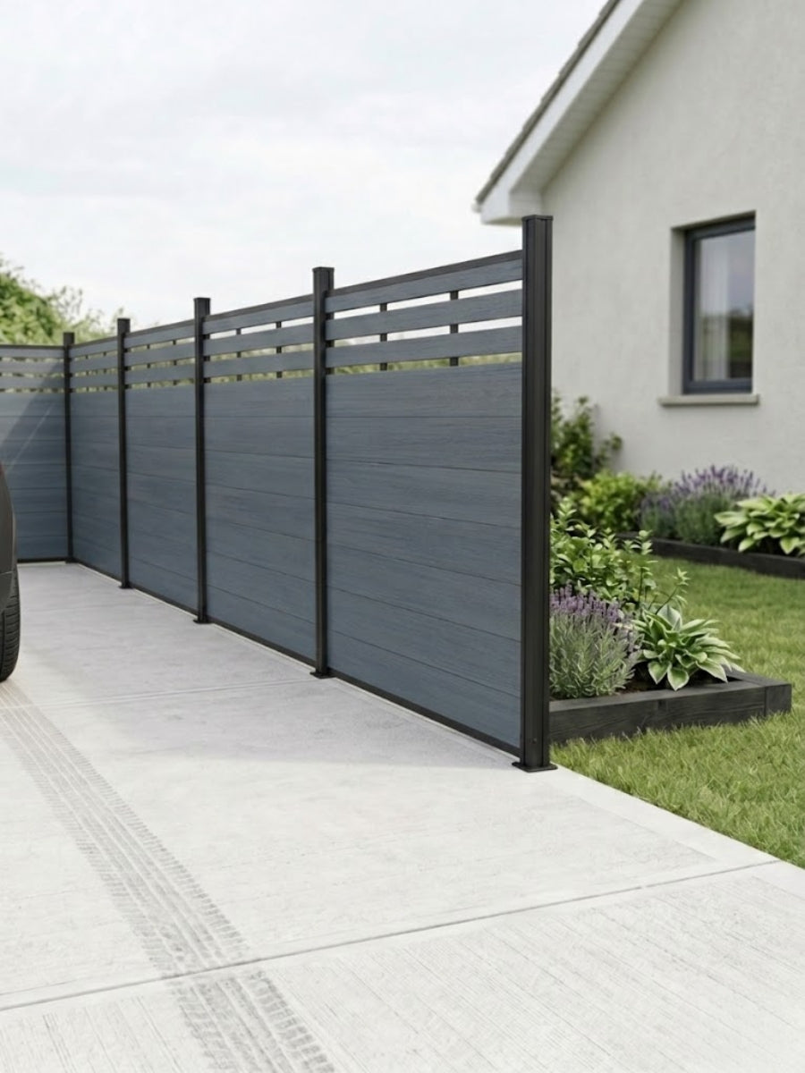 Light gray top lattice composite privacy fence installed beside a concrete driveway and garden