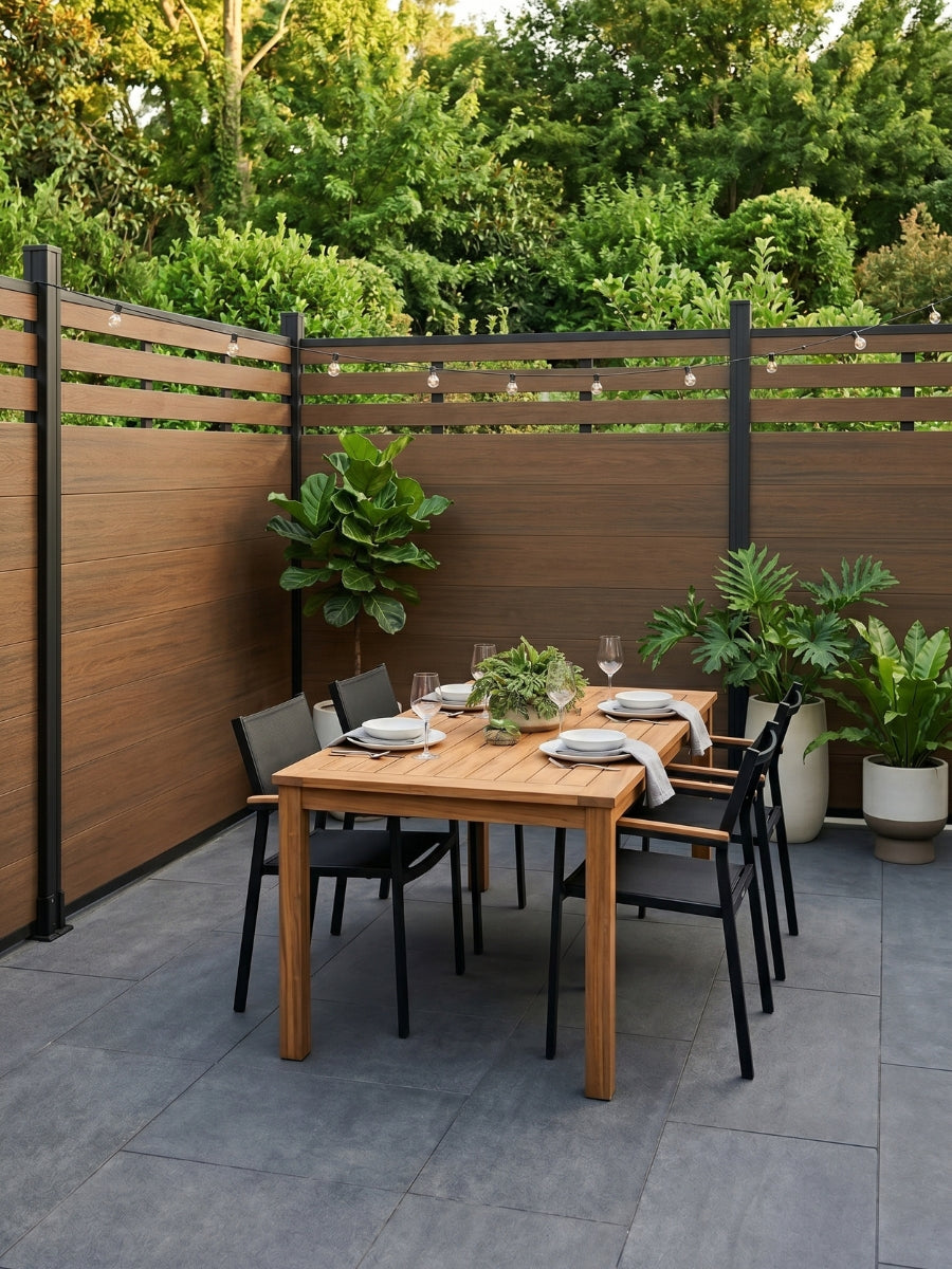 Walnut lattice-top composite privacy fence enclosing a furnished garden dining patio