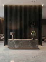 Luxe Noir WPC fluted 3D wall panels installed behind a marble reception counter