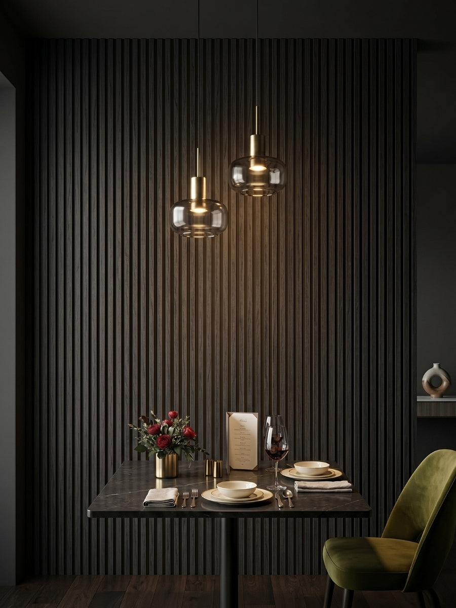 Luxe Noir black fluted wall panels creating a textured dining nook with pendant lights