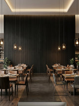Luxe Noir black fluted 3D wall panels forming a dramatic accent wall in a restaurant dining room