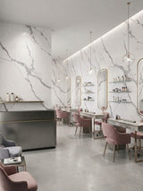 Modern salon with white and gray Matte Calacatta Belga PVC marble panels lining the styling station walls