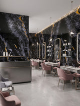 Midnight Gold Marble PVC wall panels lining a contemporary salon with illuminated mirrors and pink chairs