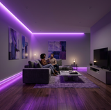 Modern living room with purple LED baseboard lighting along the floor and matching ceiling accent light