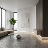 White LED baseboard molding installed around a modern living room with warm white perimeter lighting
