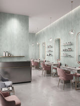 Pale green travertine-effect PVC panels installed throughout a modern beauty salon