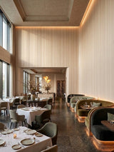 Nordic birch wood veneer panels lining the tall walls of an elegant restaurant dining area