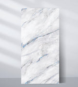 White PVC marble sheet sample with soft gray movement and blue accent veins