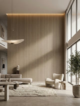 Floor-to-ceiling Royal Oak wood veneer panel wall in a minimalist living room with neutral furnishings