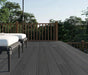 Dark gray co-extruded composite decking with brown wooden railing