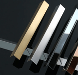 Metal edge strips with angled profiles in gold, silver, black, and bronze finishes