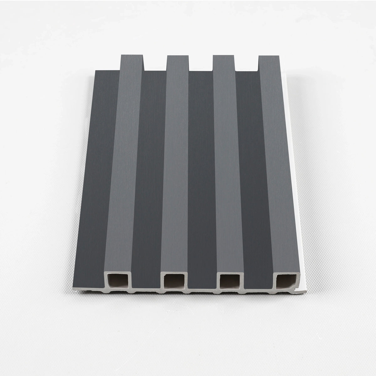 Silver gray WPC slat fluted wall panel sample with a dark metallic-look finish
