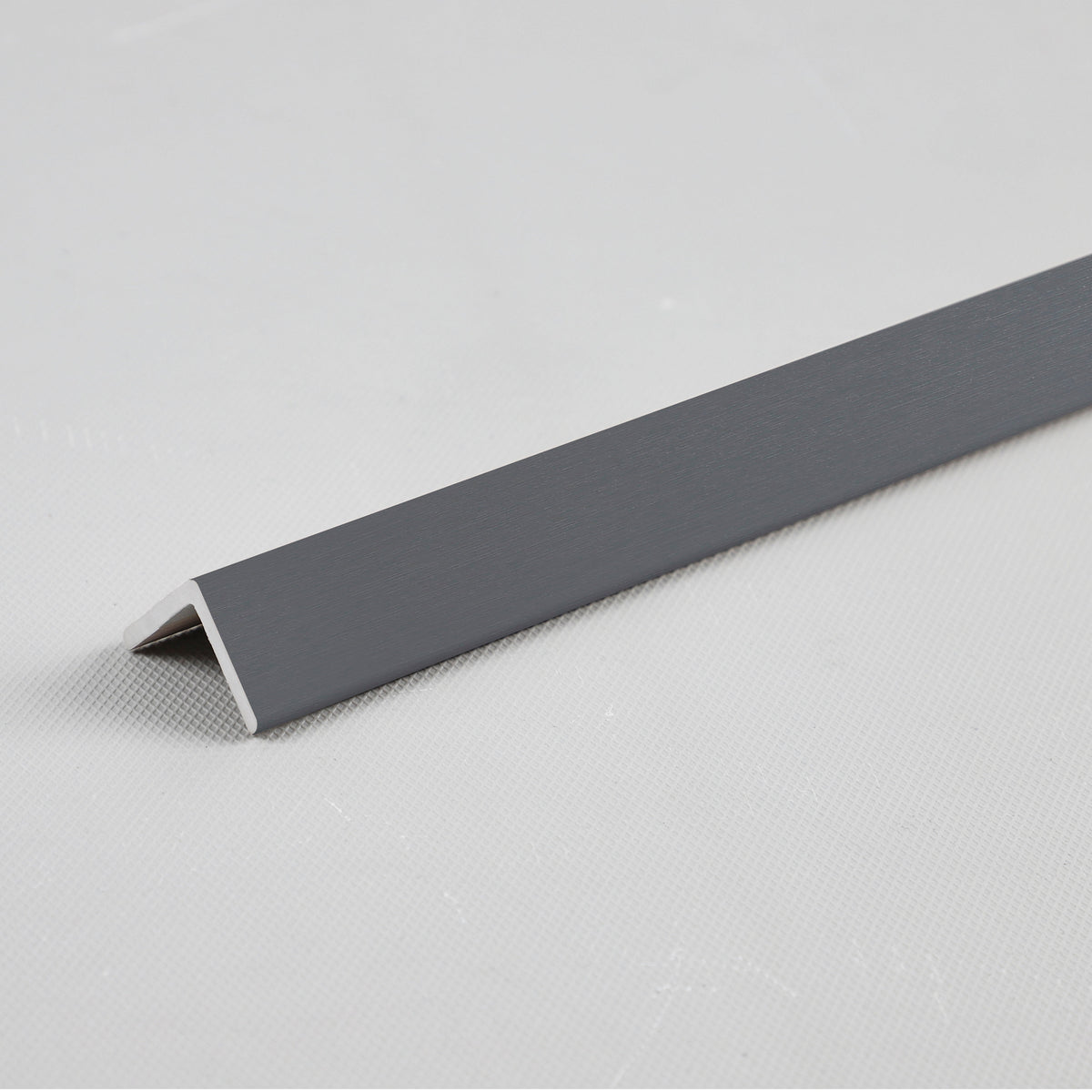 Silver gray metallic angled trim piece for WPC fluted 3D wall panels