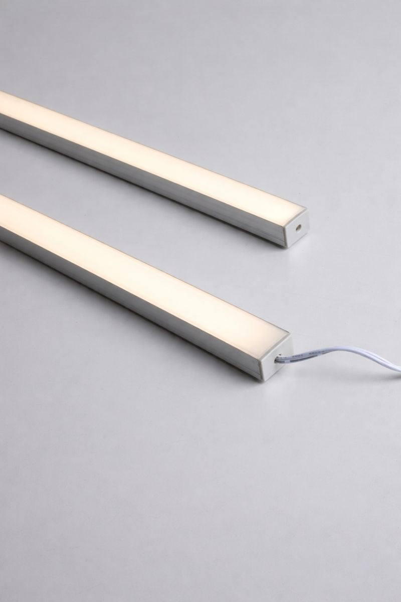 Close-up of two illuminated smart LED strip light bars and connecting wire