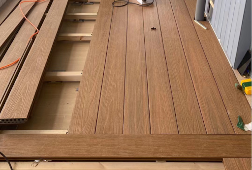 Light brown teak composite decking board with natural wood grain