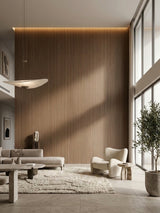 Tall walnut wood veneer panel feature wall in a bright contemporary living room