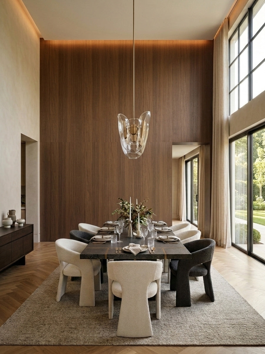 Walnut wood veneer panels covering a high dining room wall with warm recessed lighting