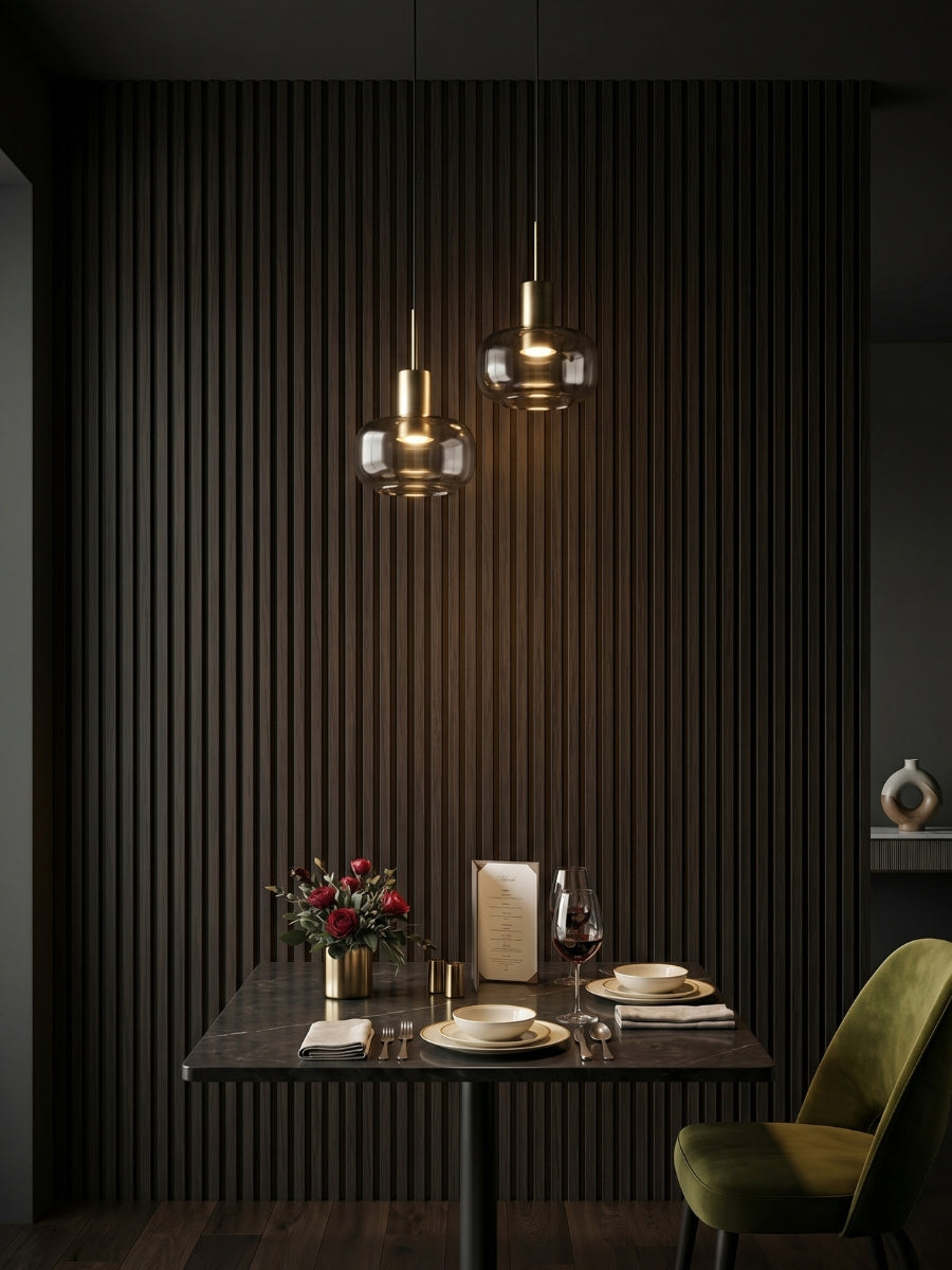 Walnut Ink Metallic 3D fluted wall panels installed behind an intimate dining table with pendant lights