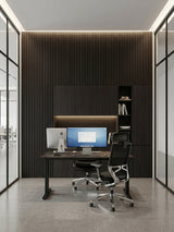 Modern office with Walnut Ink Metallic fluted wall panels behind a desk and dark built-in cabinets