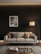 Living room with a gray sofa set against a Walnut Ink Metallic fluted wall panel backdrop