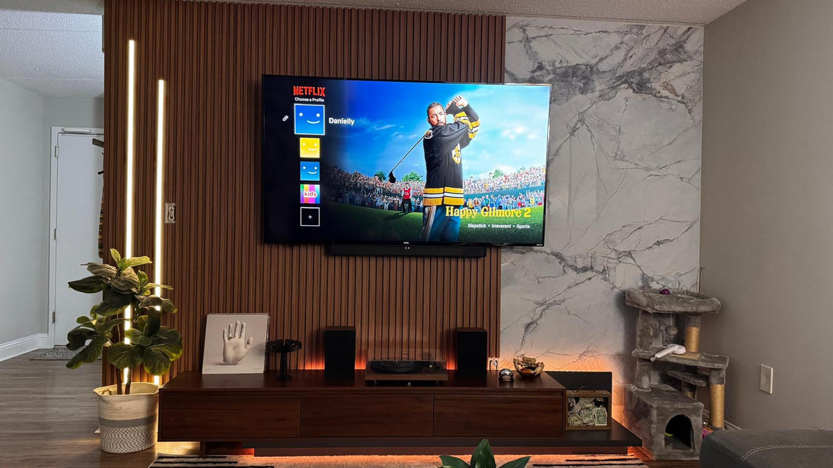 Warm white smart LED strip lights accenting a slatted TV wall and media console