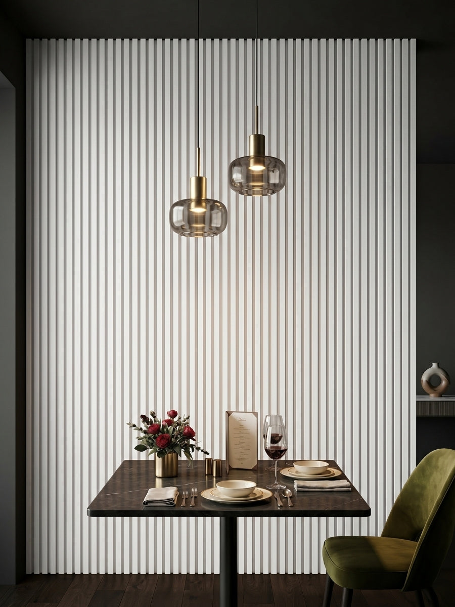 White brushed WPC fluted wall panels installed behind a dining table with pendant lights