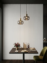 White brushed WPC fluted wall panels installed behind a dining table with pendant lights