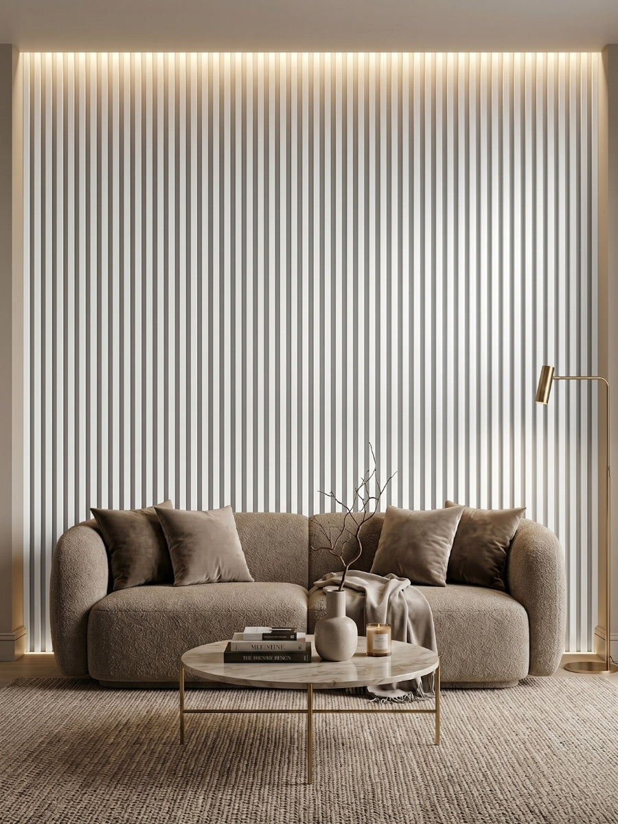 Floor-to-ceiling white brushed fluted wall panels creating a backlit accent wall behind a curved sofa