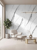 White matte marble PVC wall panels with bold gray veining in a lounge with an armchair and indoor plant
