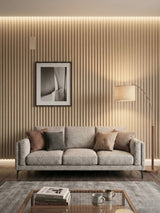 White oak WPC fluted 3D wall panels installed behind a gray living room sofa