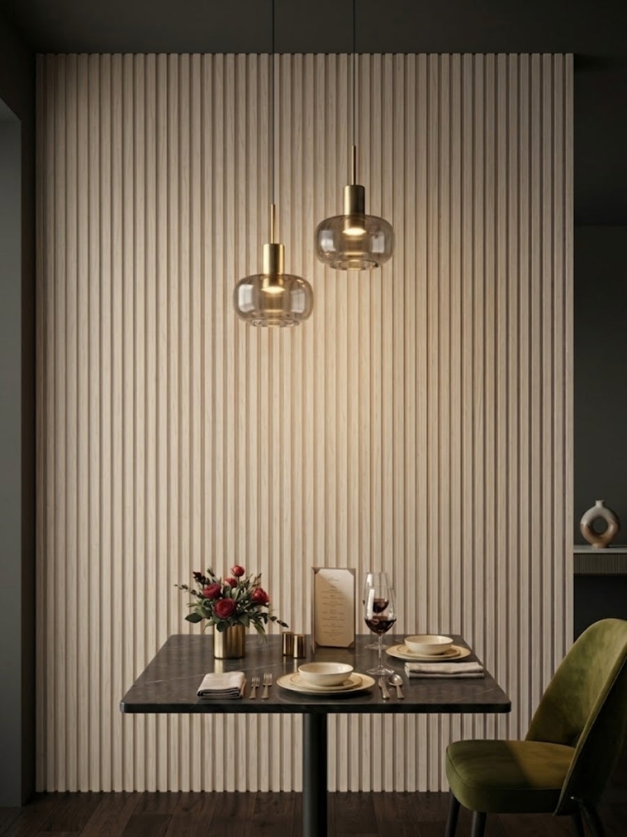 White oak WPC fluted 3D wall panels in a dining nook with pendant lights