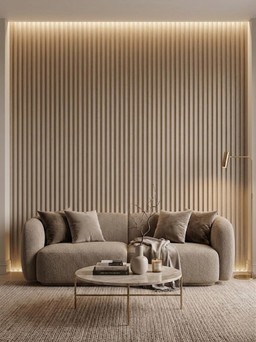 Floor-to-ceiling white oak WPC fluted wall panels framing a curved sofa