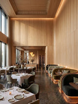 White oak veneer wall panels lining the walls and ceiling of an upscale restaurant dining room