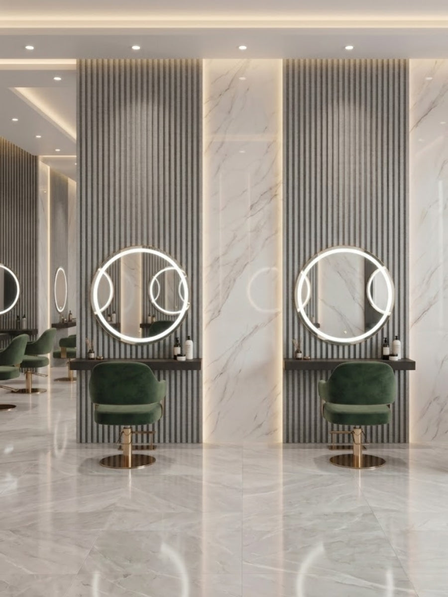 White linen fluted wall panels framing illuminated round mirrors and green salon chairs
